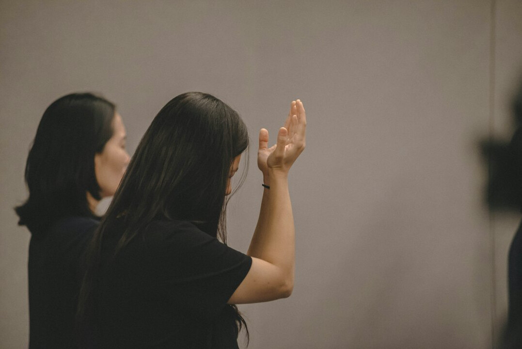 woman practicing speech in mirror