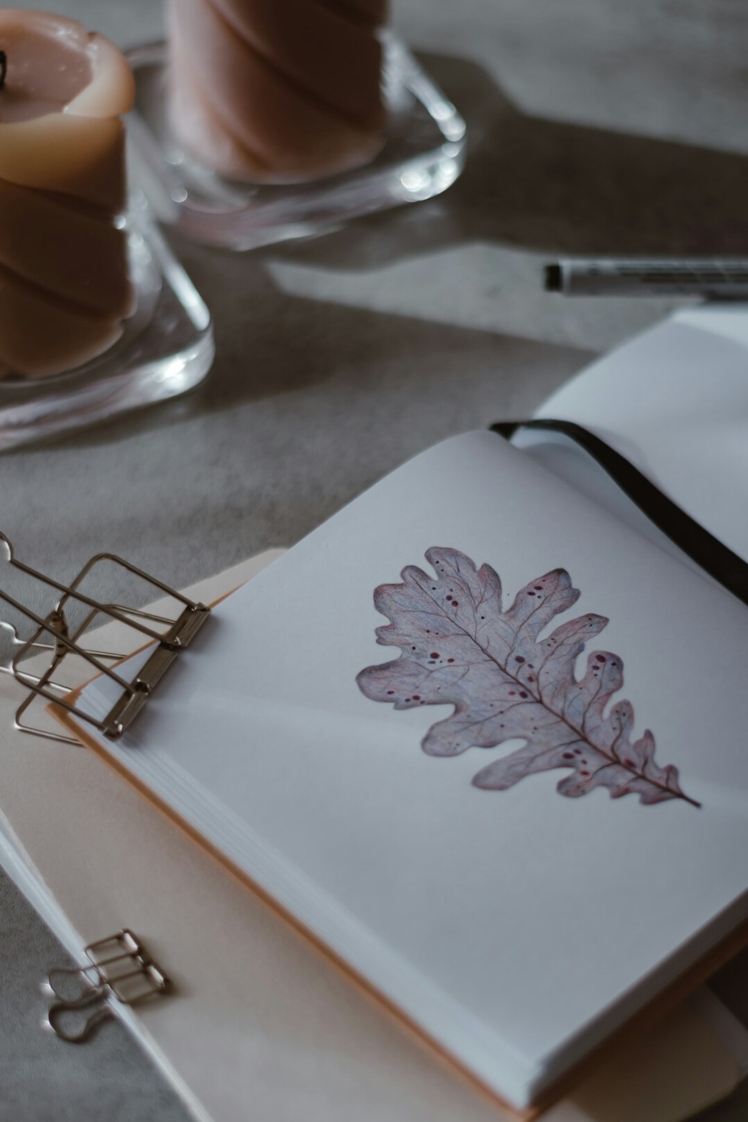 Notebook with pen and papers on a table